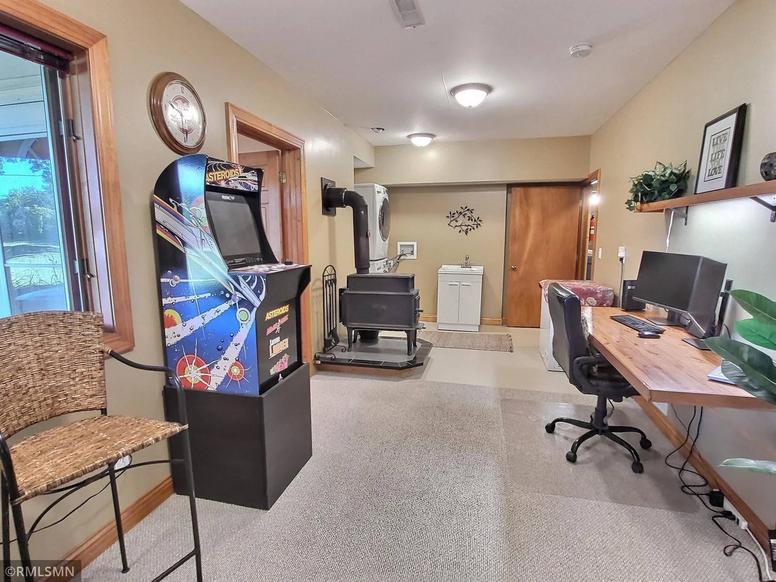 Adjacent to the great room, a flex area currently serves as a home office, with laundry facilities conveniently nearby. The woodstove will provide wonderful winter warmth.