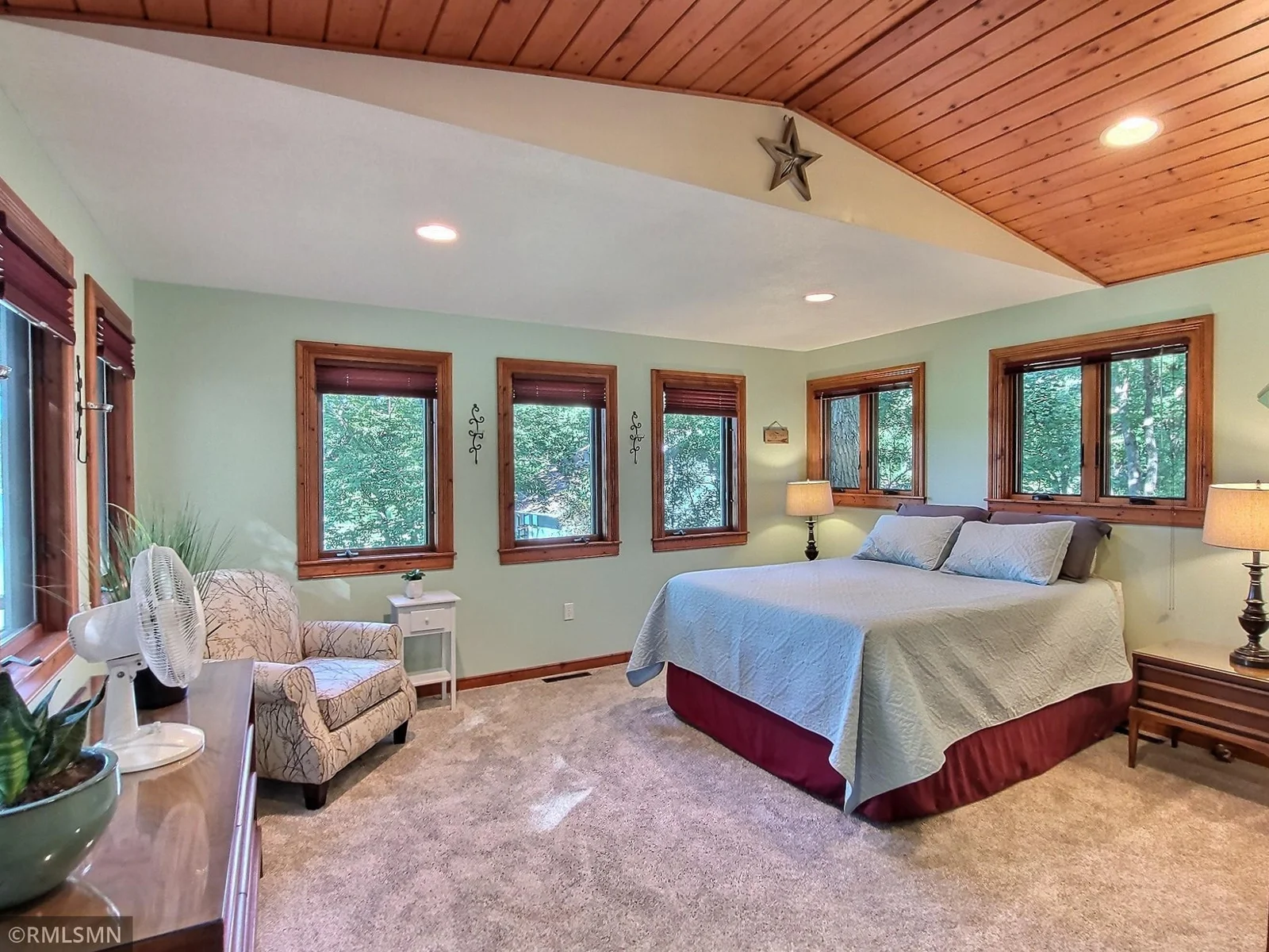 The primary bedroom is especially inviting, with plenty of windows to let the outdoors in.