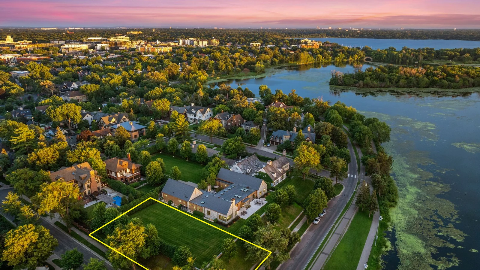 2501 East Lake of the Isles Parkway. The yellow outline on photo highlights the approximate boundaries (90x186x90x178) of the vacant lot.