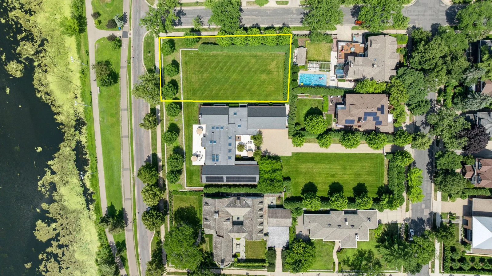 2501 East Lake of the Isles Parkway. The yellow outline on photo highlights the approximate boundaries (90x186x90x178) of the vacant lot.