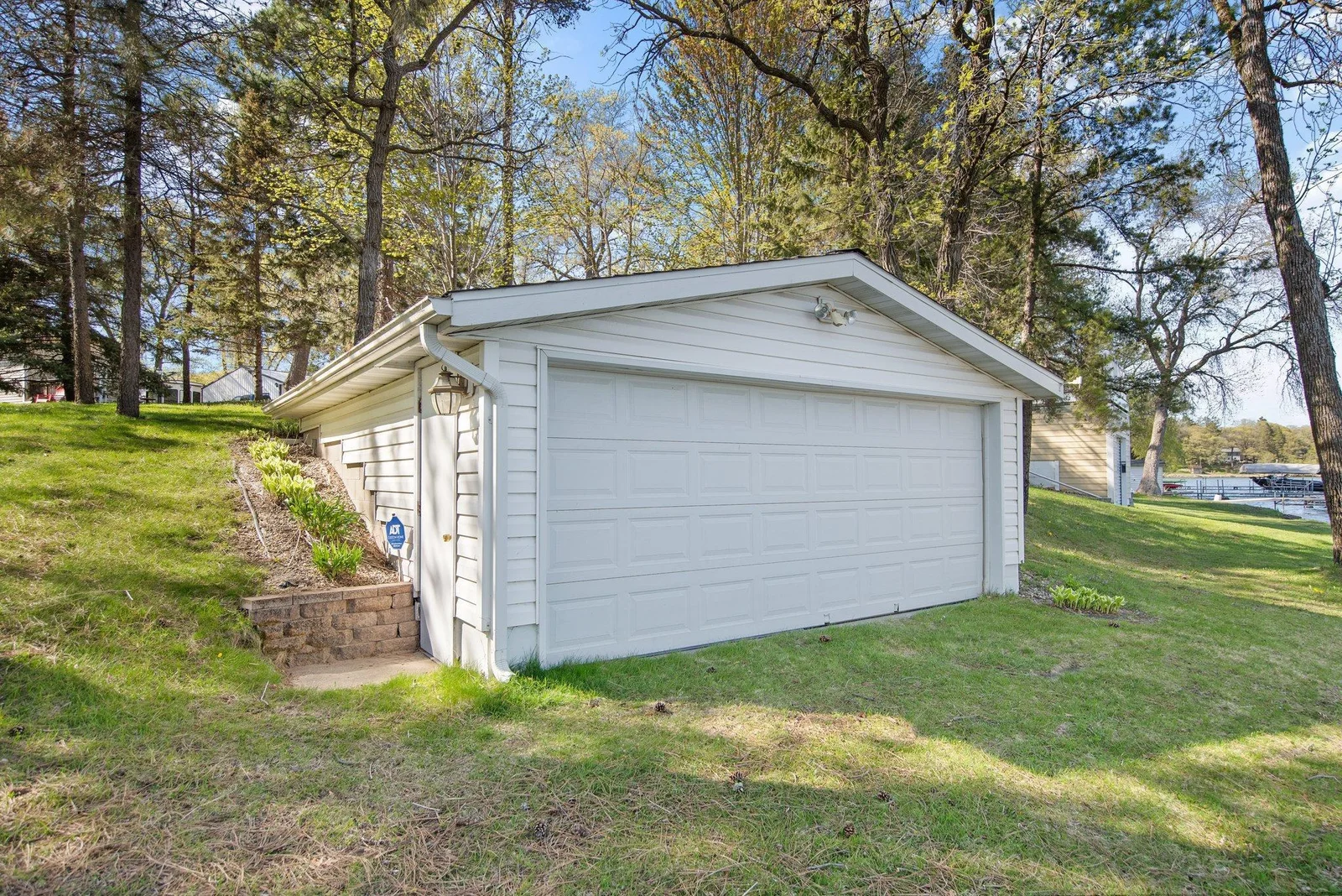 Nestled down by the lake is this multipurpose boathouse/garage ready for all of your lake toys and storage!