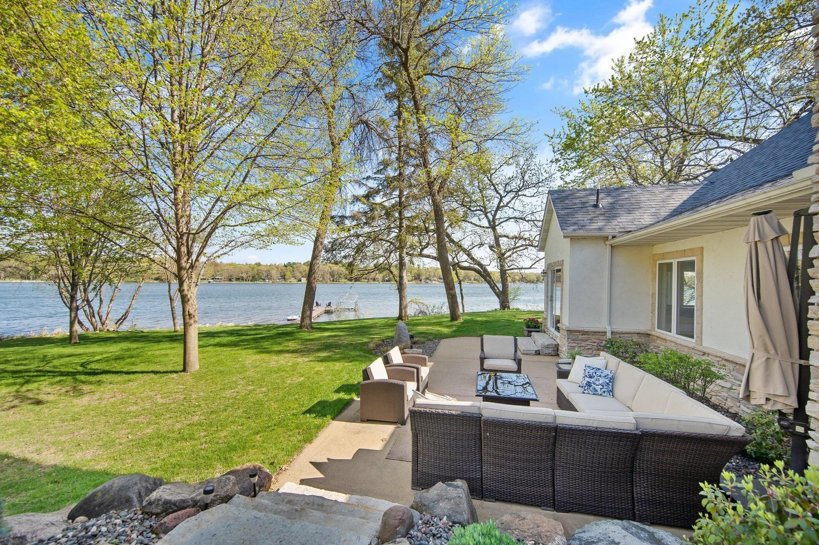 Surrounded by custom landscaping, home also features an oversized concrete patio allowing for even more entertaining space, and areas to enjoy the exceptional privacy and views.