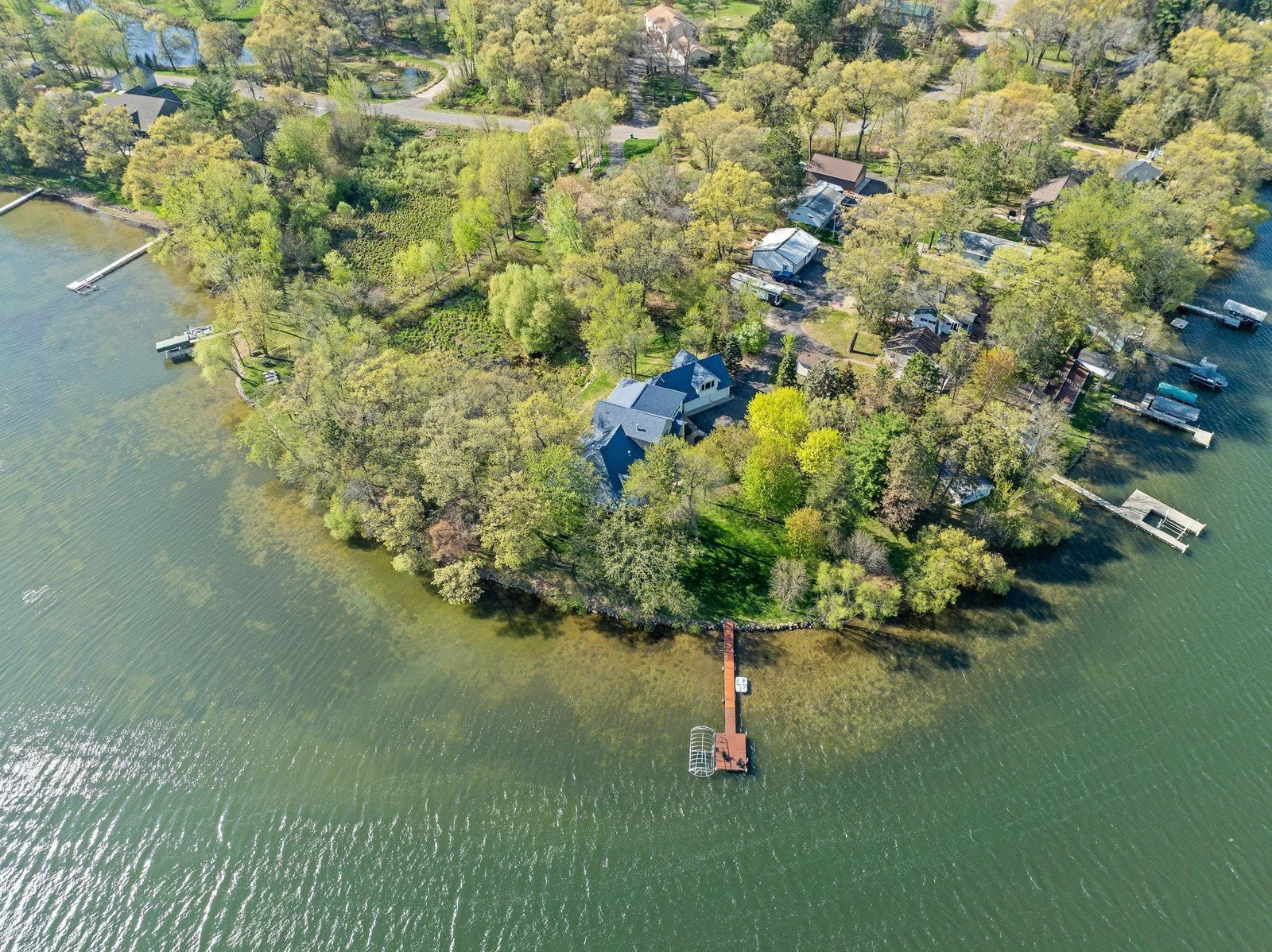 Privacy, 450 feet of lake shore, panoramic views out of every window, and custom updates throughout- the search is over, Welcome Home!