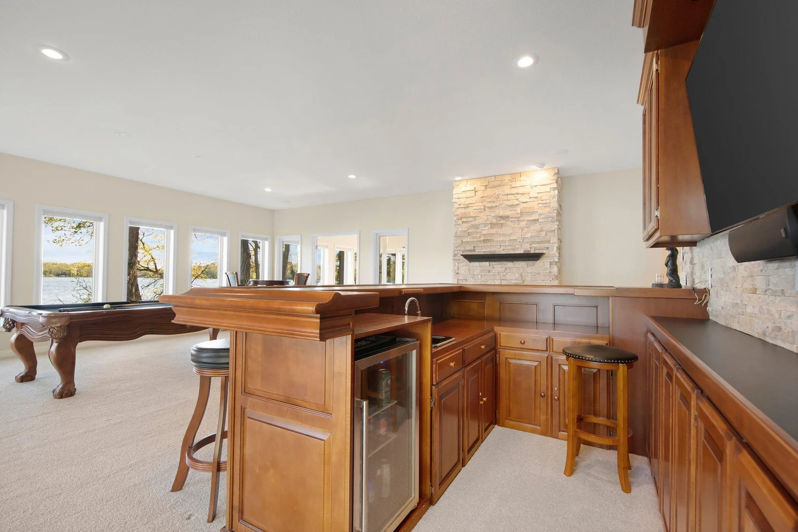 Custom wet bar features sink and beverage station.