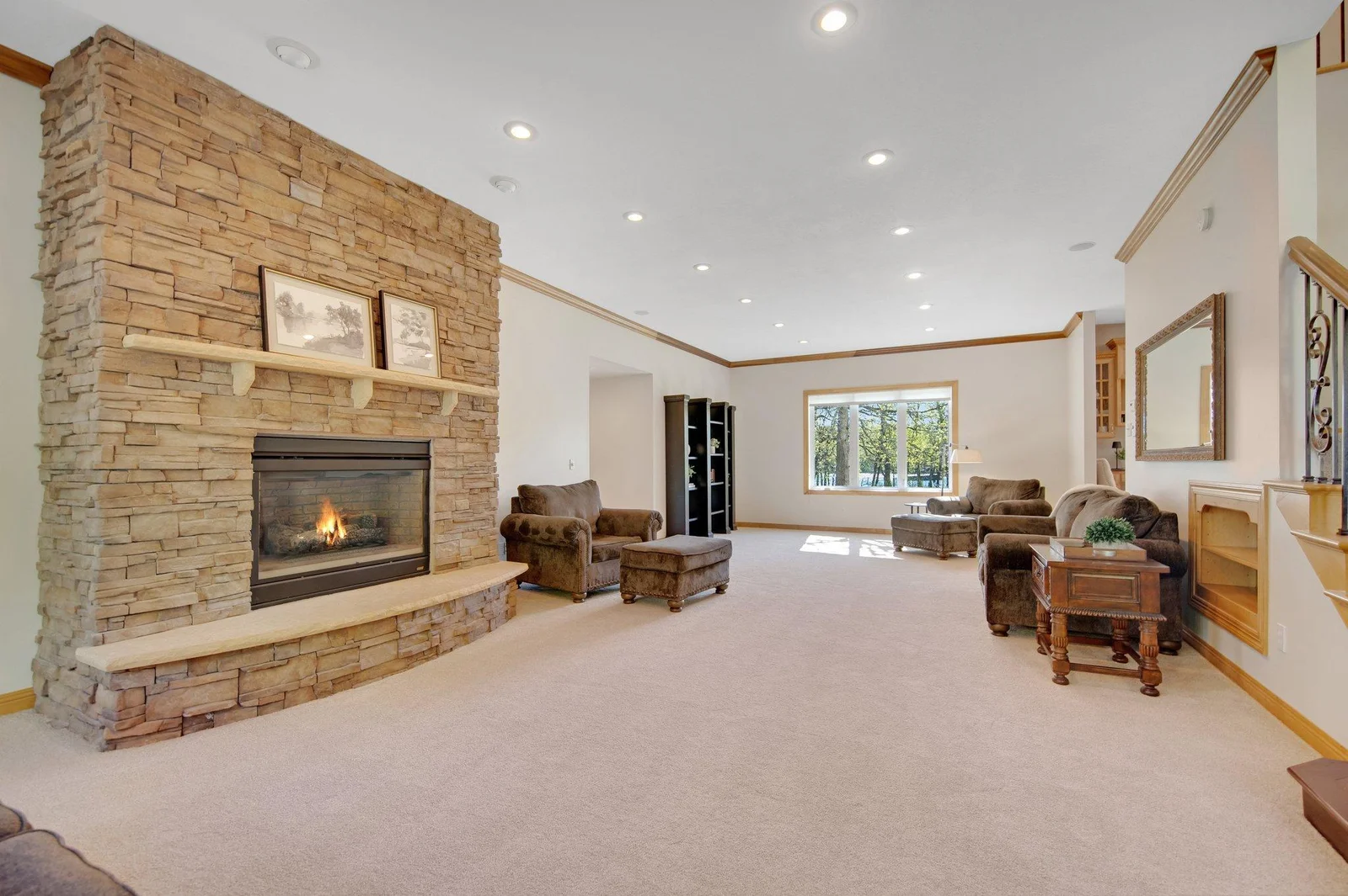 Custom stone floor to ceiling gas fireplace.