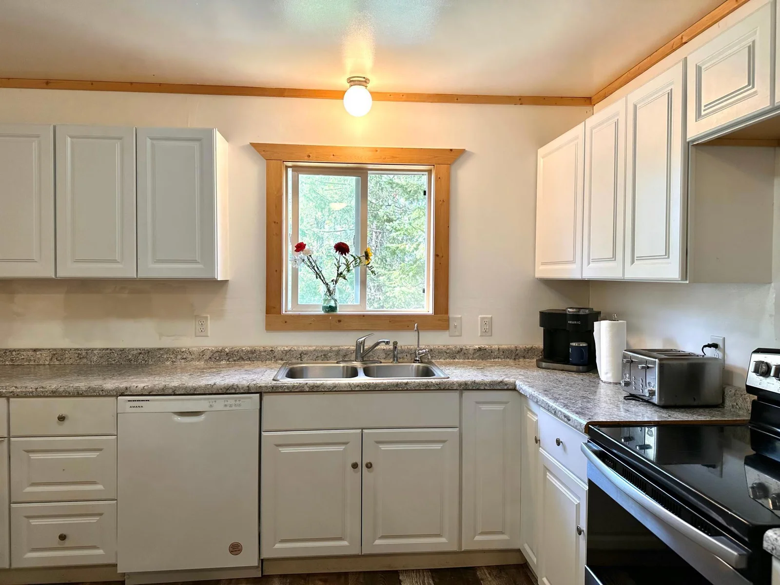 What a light airy kitchen with lots of countertop space.