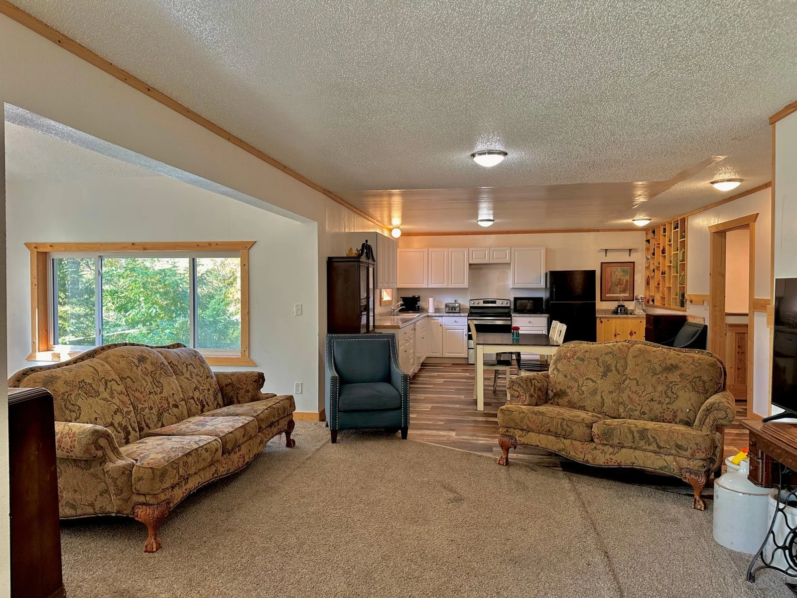to the right is a dining/office space and there are two bedrooms behind me.