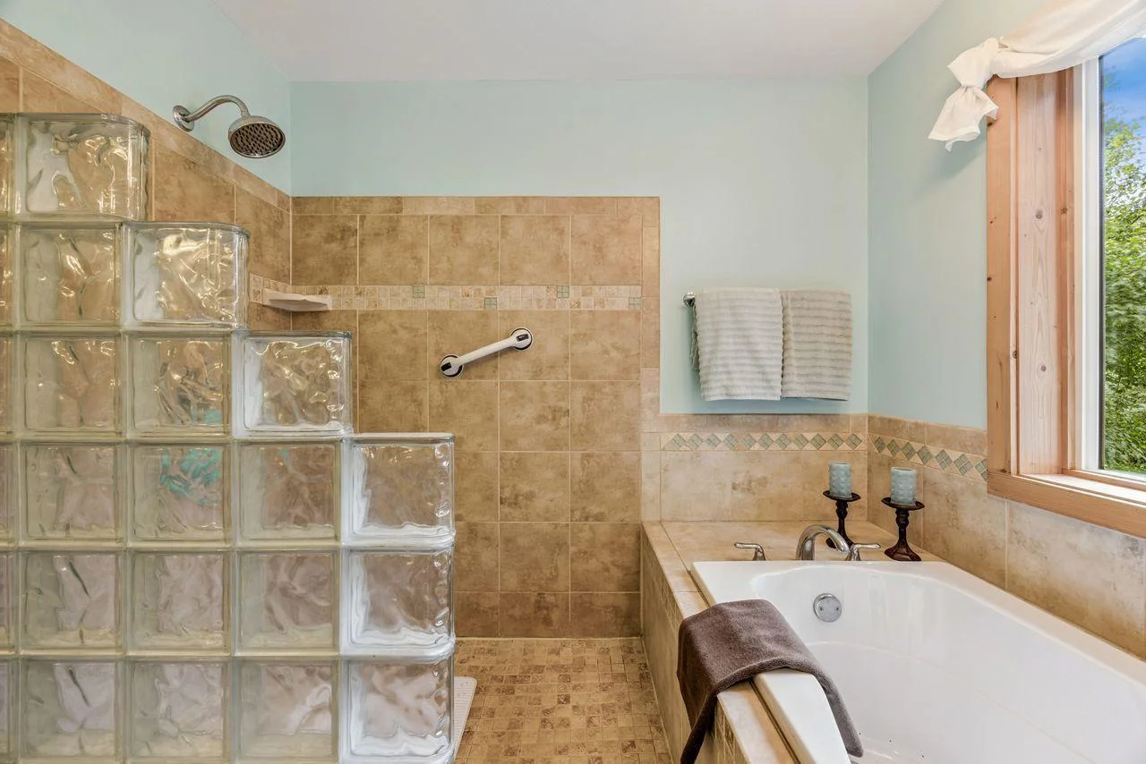 Walk in shower and whirlpool tub.