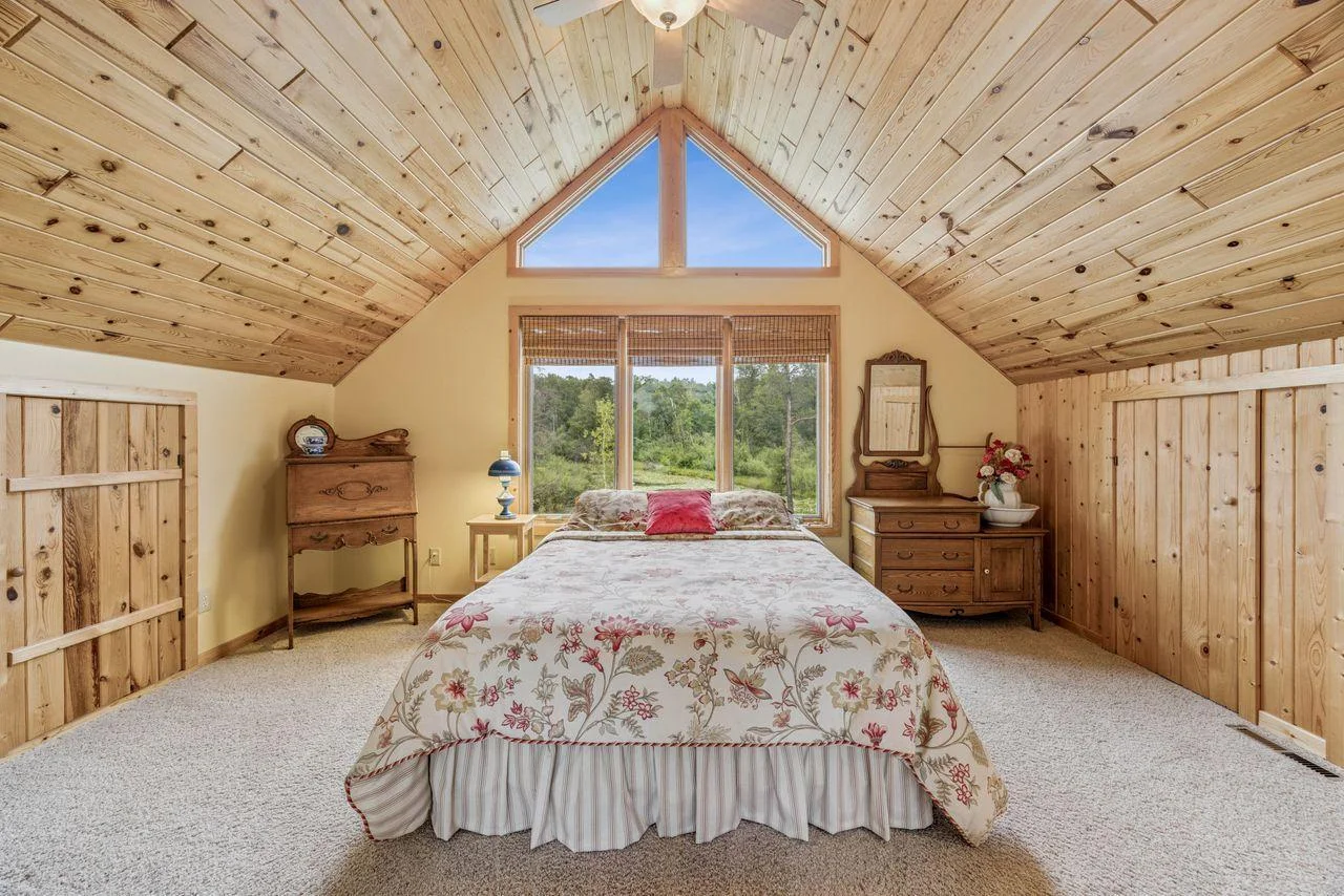 Upper level guest bedroom with views of the pond and lake.