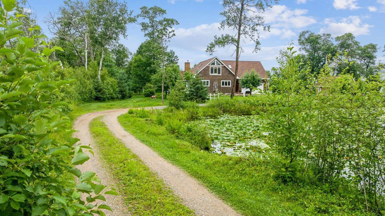 Driveway from road to house going over pond.