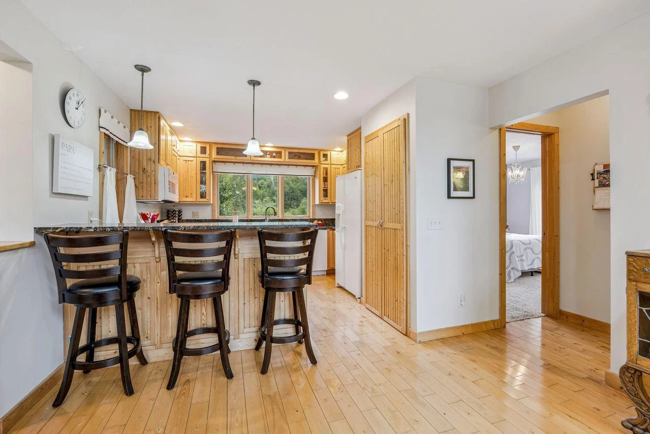 Breakfast bar looking into kitchen with view of the pond.