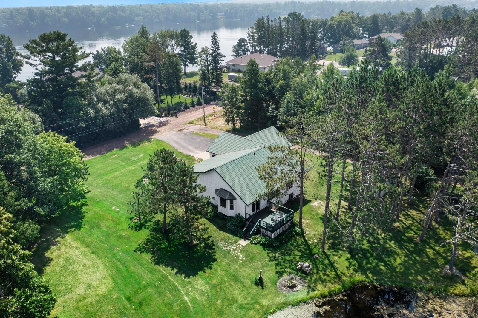 A gorgeous lot with mature trees and a view of the lake.