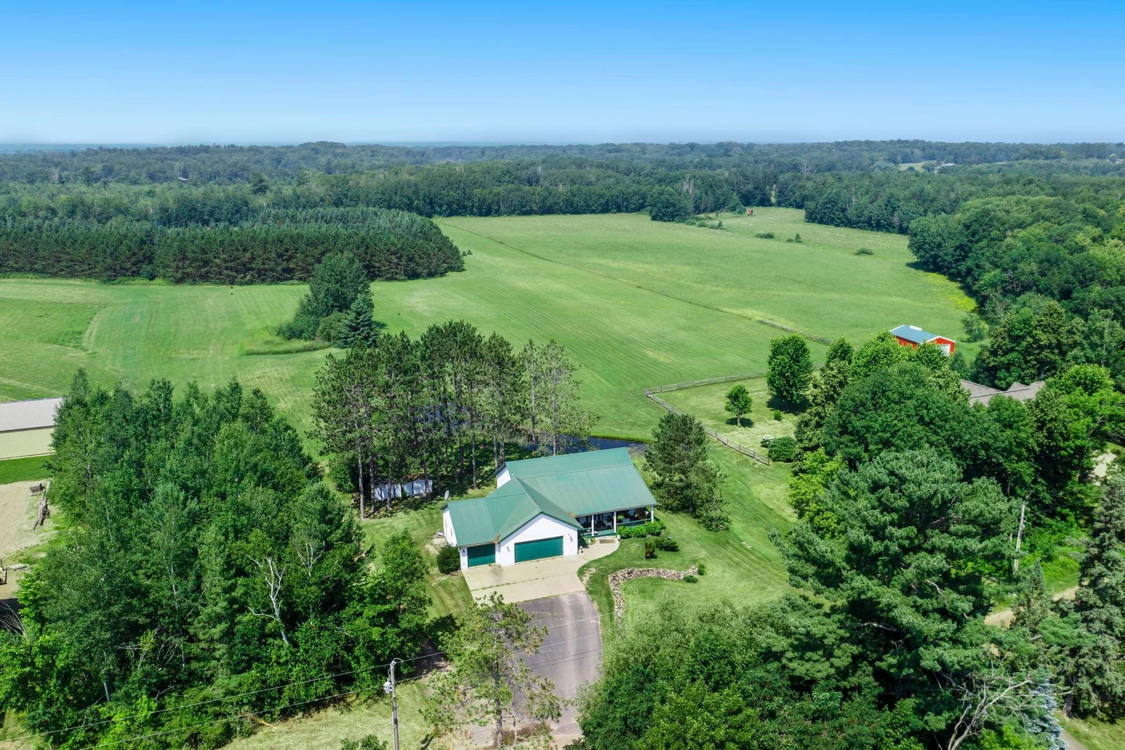 Comprised of two parcels, the home sits on just under one acre of gently rolling hills.