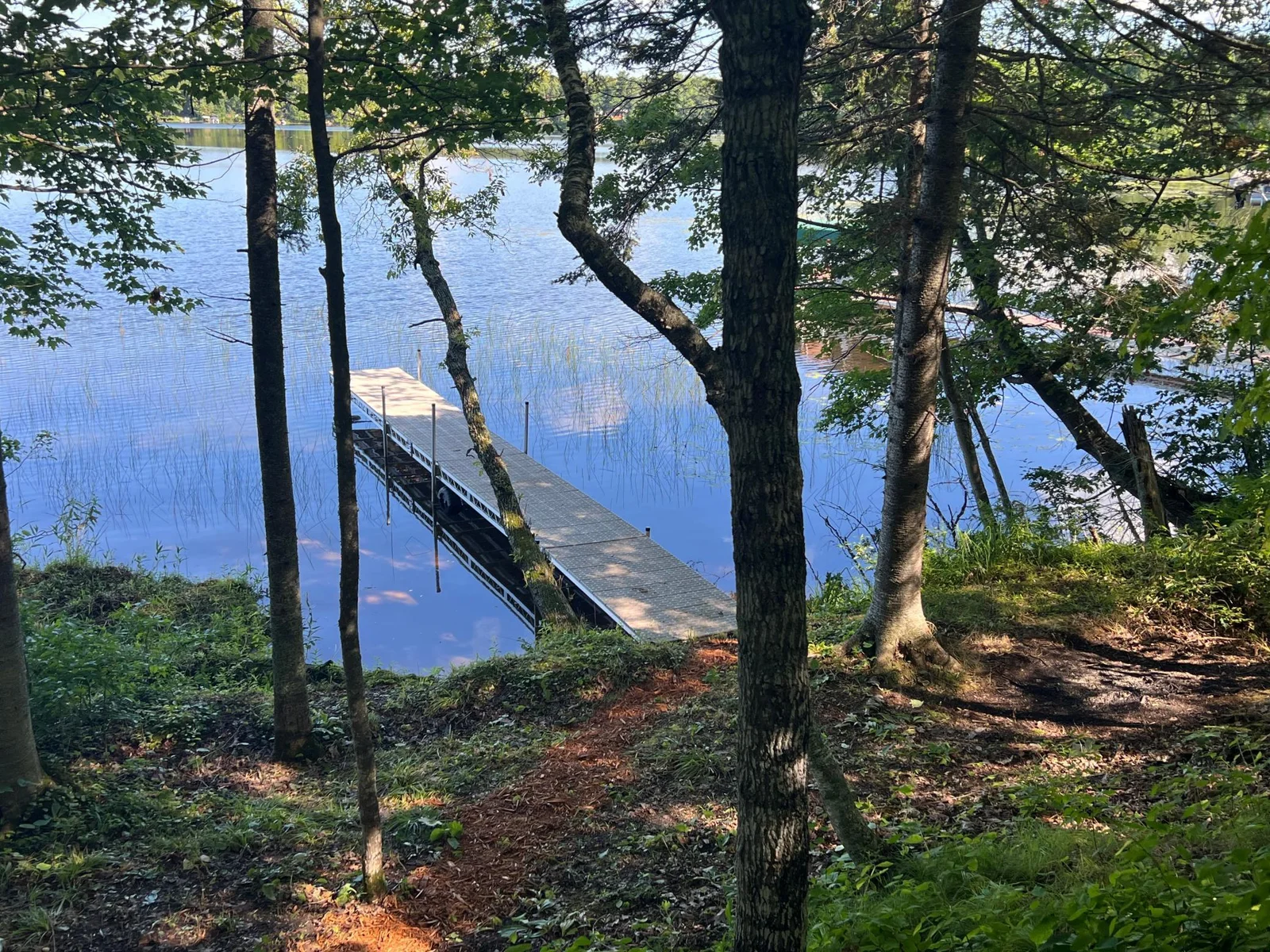 ITHE VIEW OF THE DOCK AND LAKE FROM THE PATH.