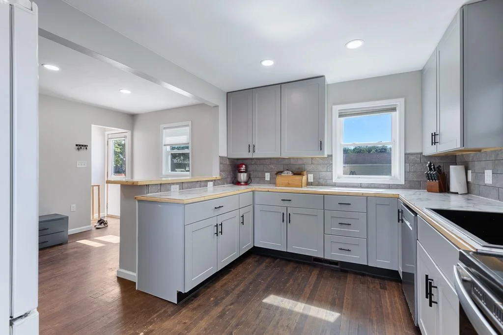 Although kitchen/dining is an open shared space, the wrap around island creates a nice boundary for each area