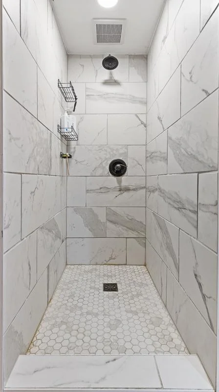 This tiled shower is the style as the main floor's primary bathroom