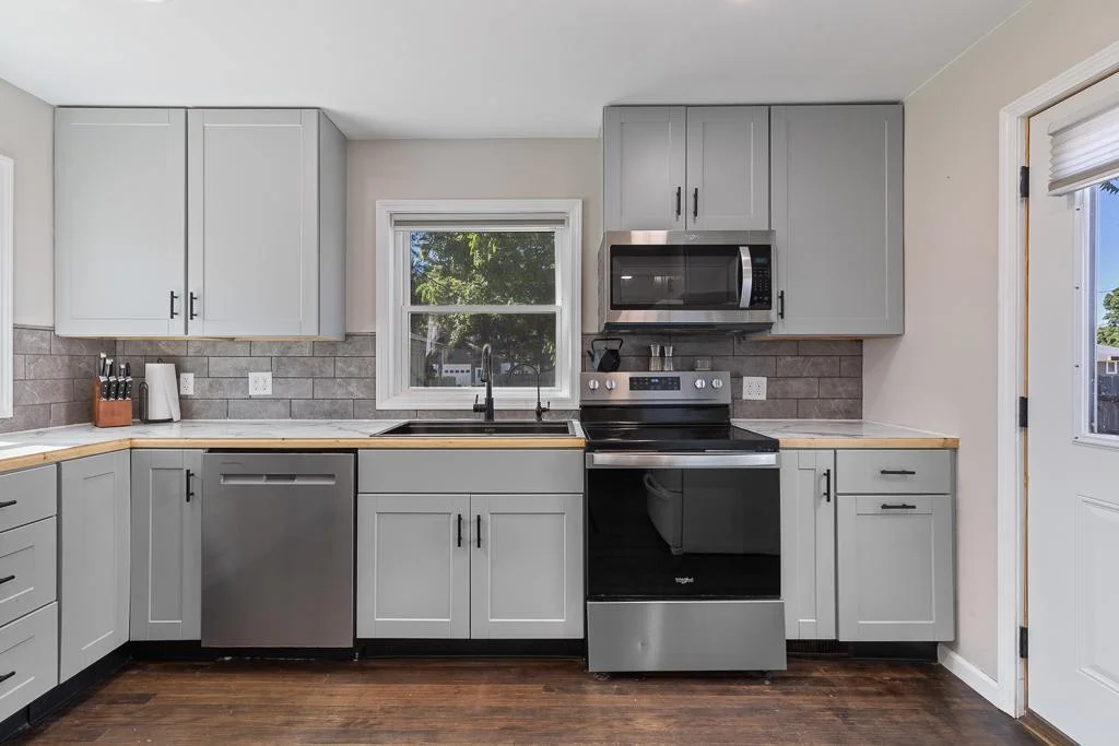 The kitchen window gives a view to the spacious, fully fenced in backyard, and you'll love backdoor access to a spacious concrete patio for outdoor meals!