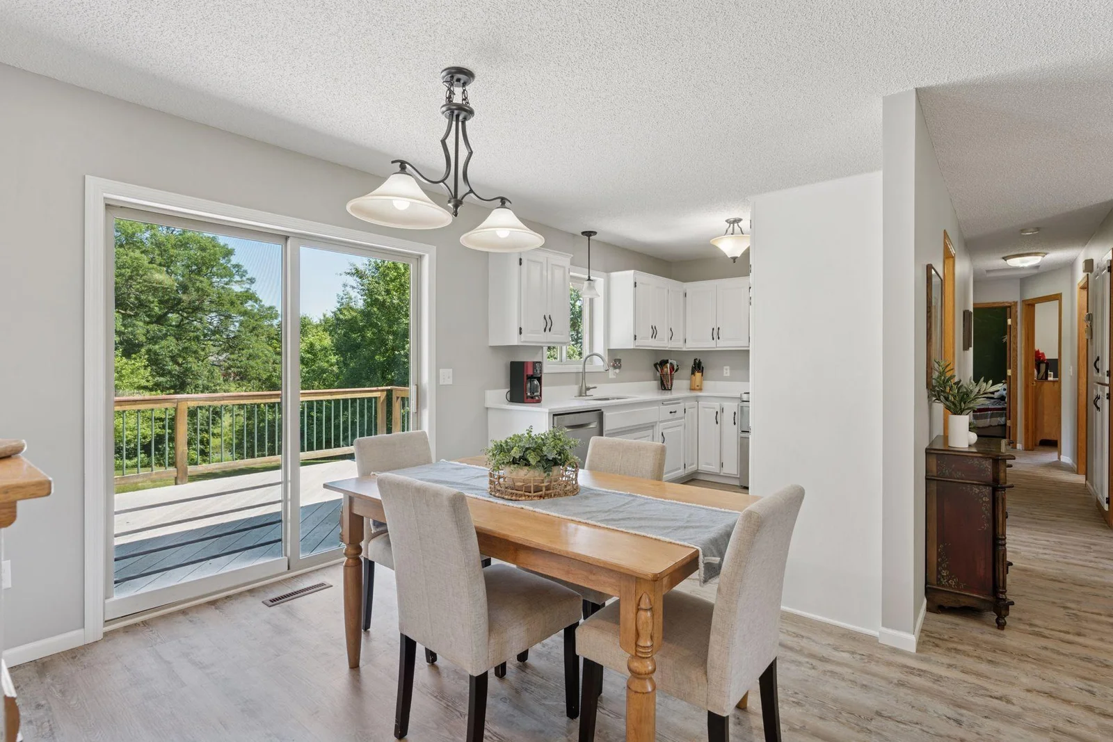 Dining space is open to the kitchen and living room and has a sliding glass door to the deck.