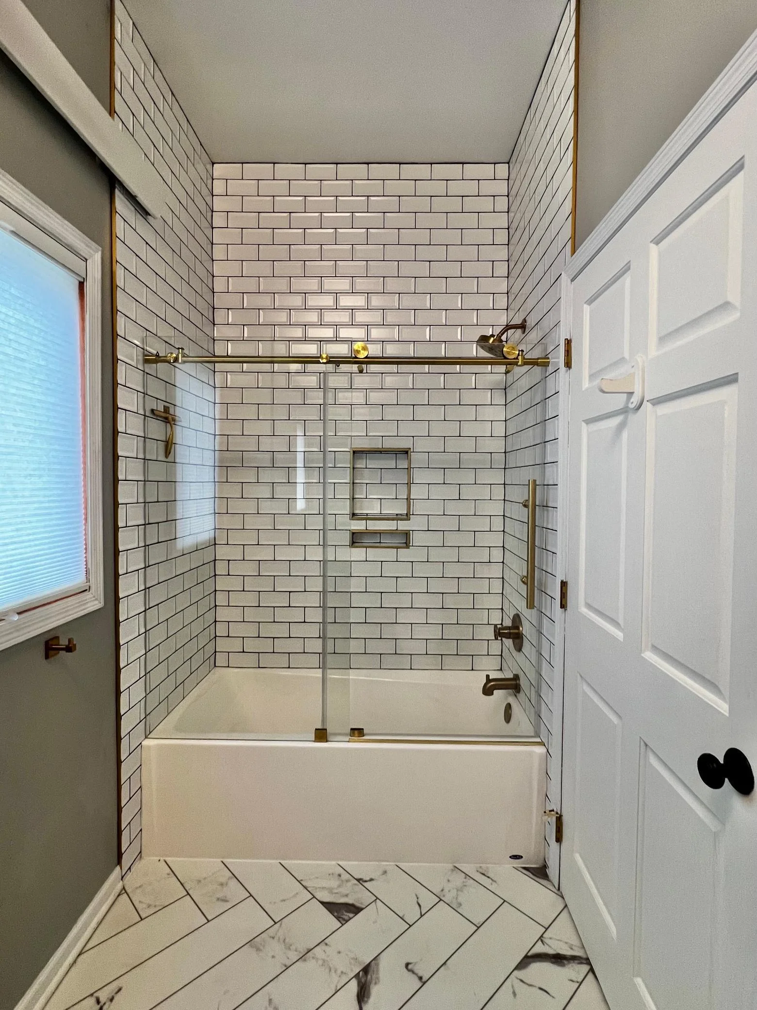 Main Floor Full Bathroom with New LVP Flooring, Full Ceramic Tile Shower, Frameless Glass Doors & Fixtures.