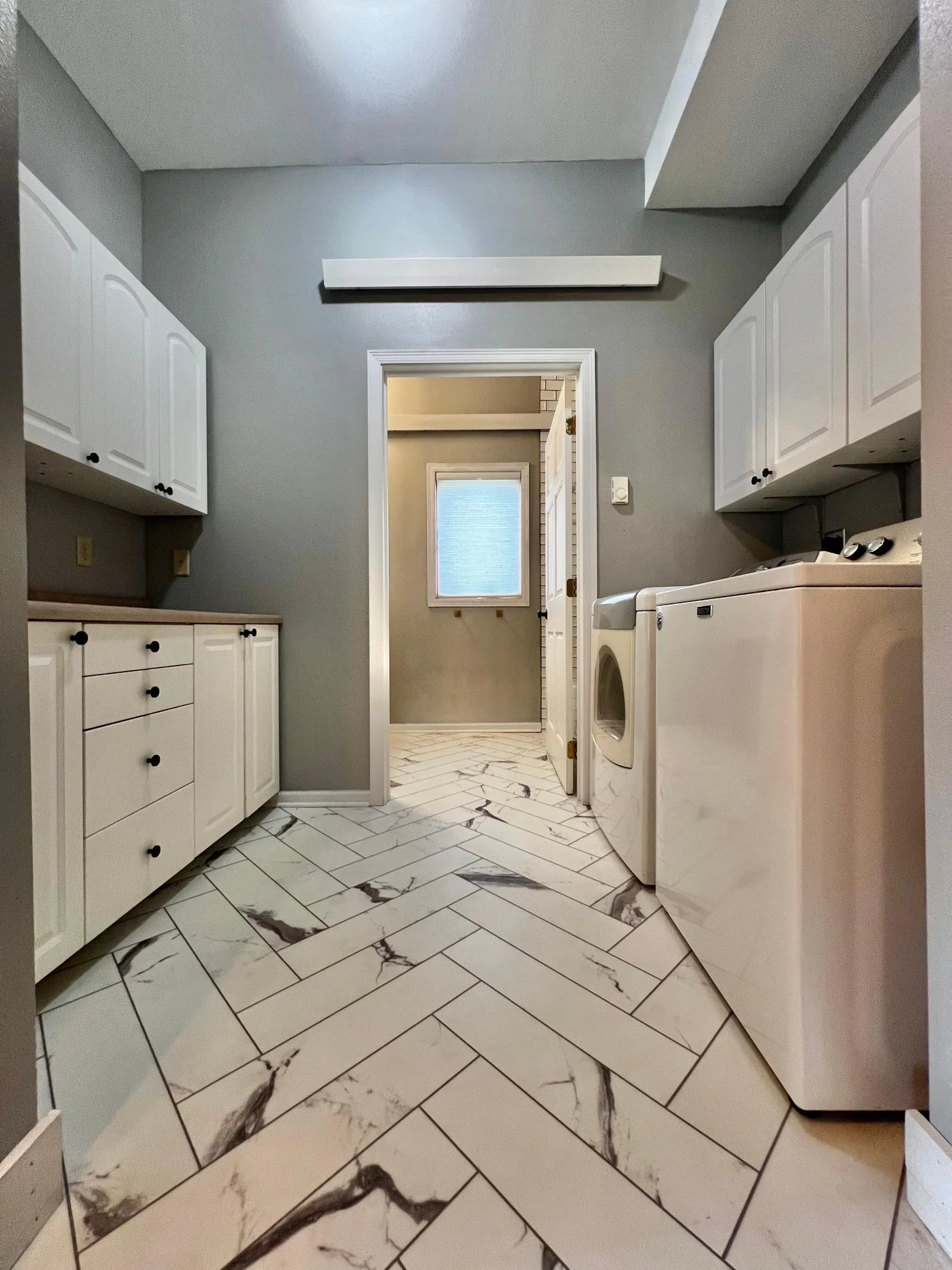 Laundry Room with view to Main Floor Full Bathroom.
