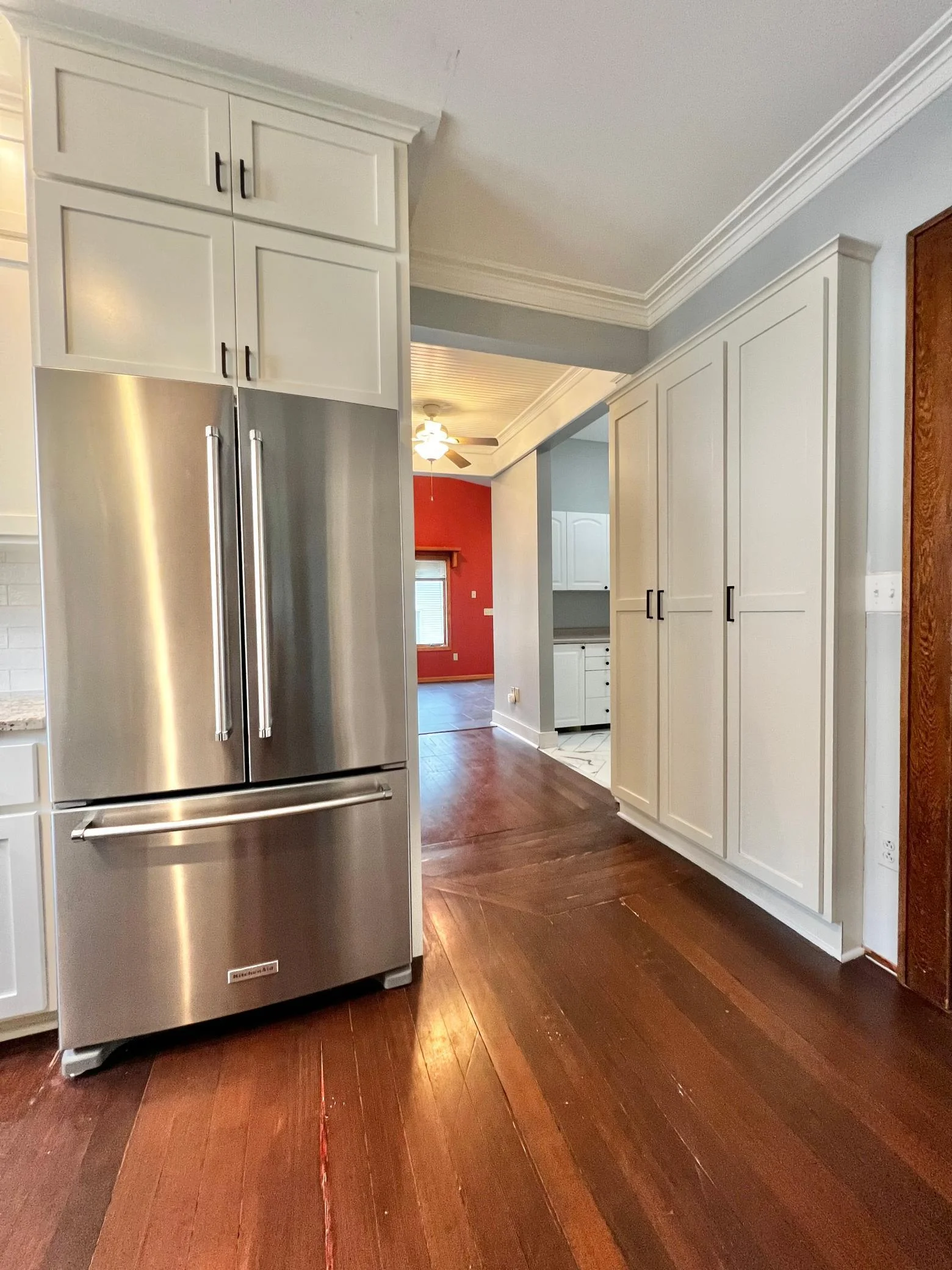Kitchen with View of hall to Laundry, Main Floor Full Bath and Family Room.