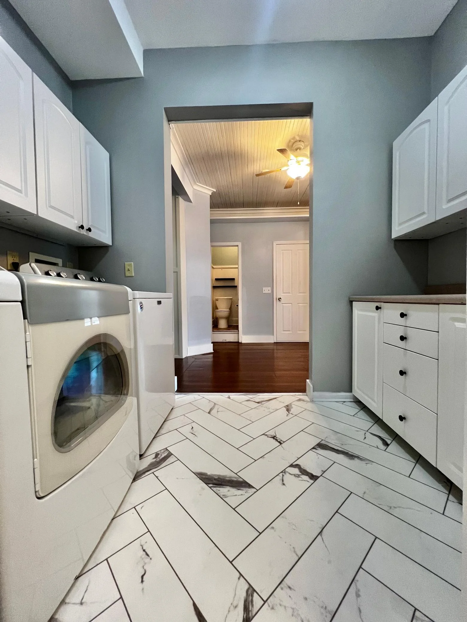Laundry Room with view of 1/2 Bath and Basement Door.