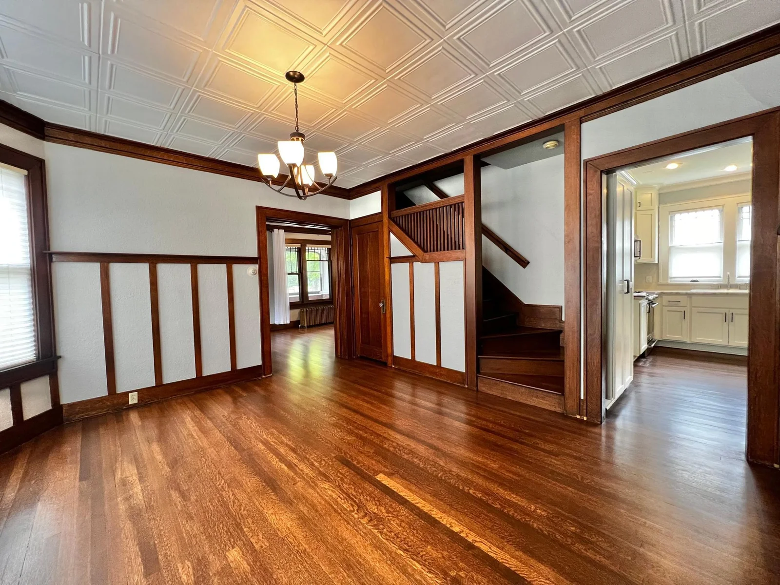 Dining Room with view to Kitchen, Living Room and Stairway to Second Floor.
