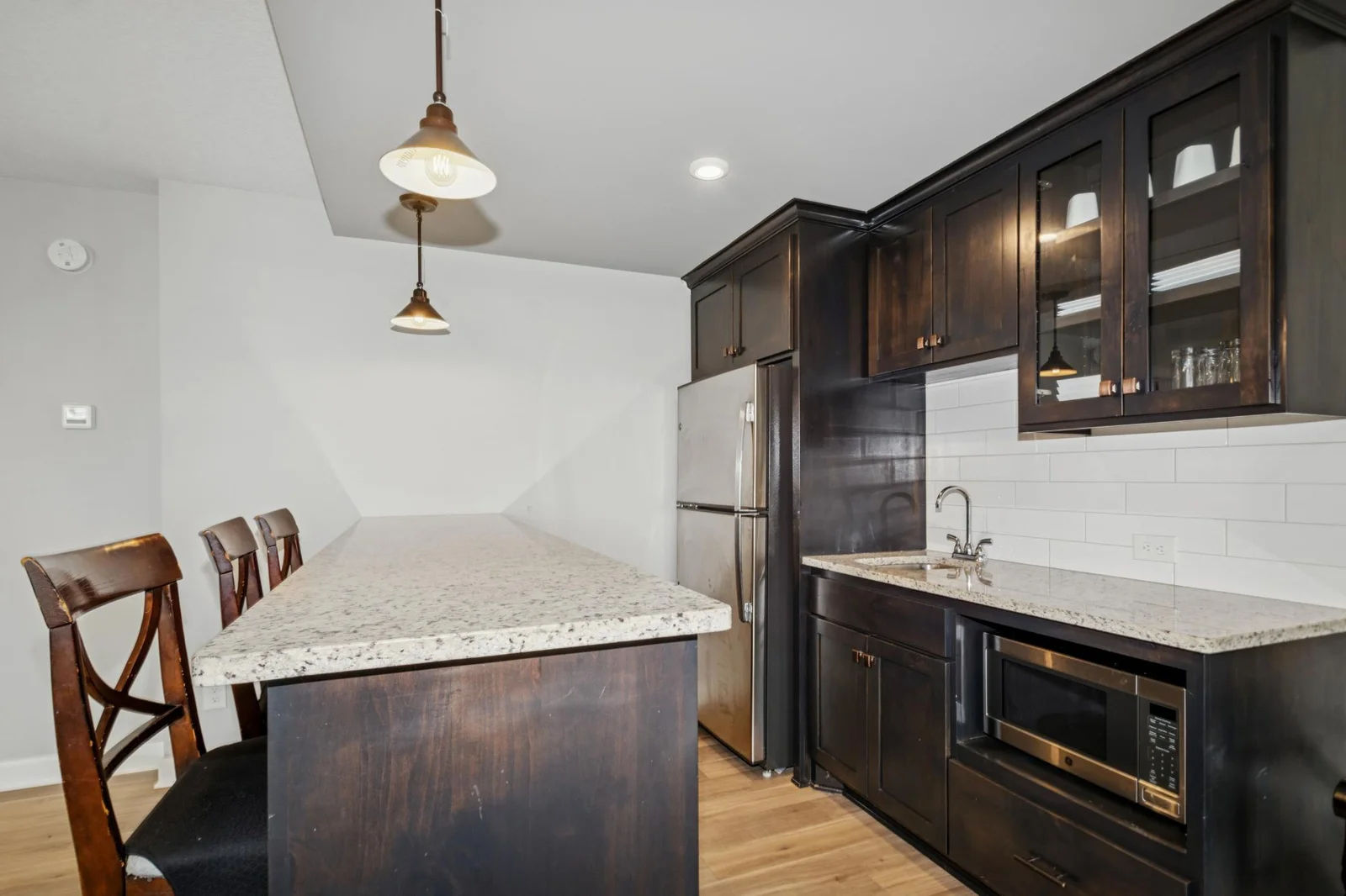 Microwave, sink and refrigerator at the LL wet bar