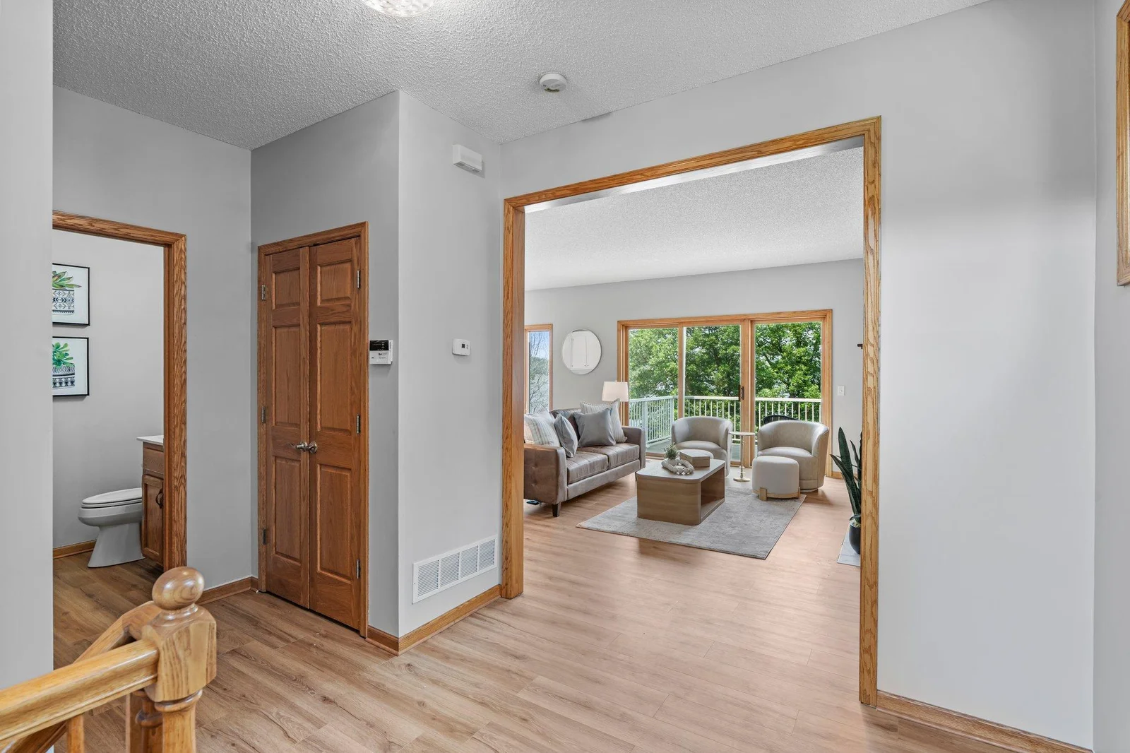 Landing with access to basement, main floor powder bath & living room