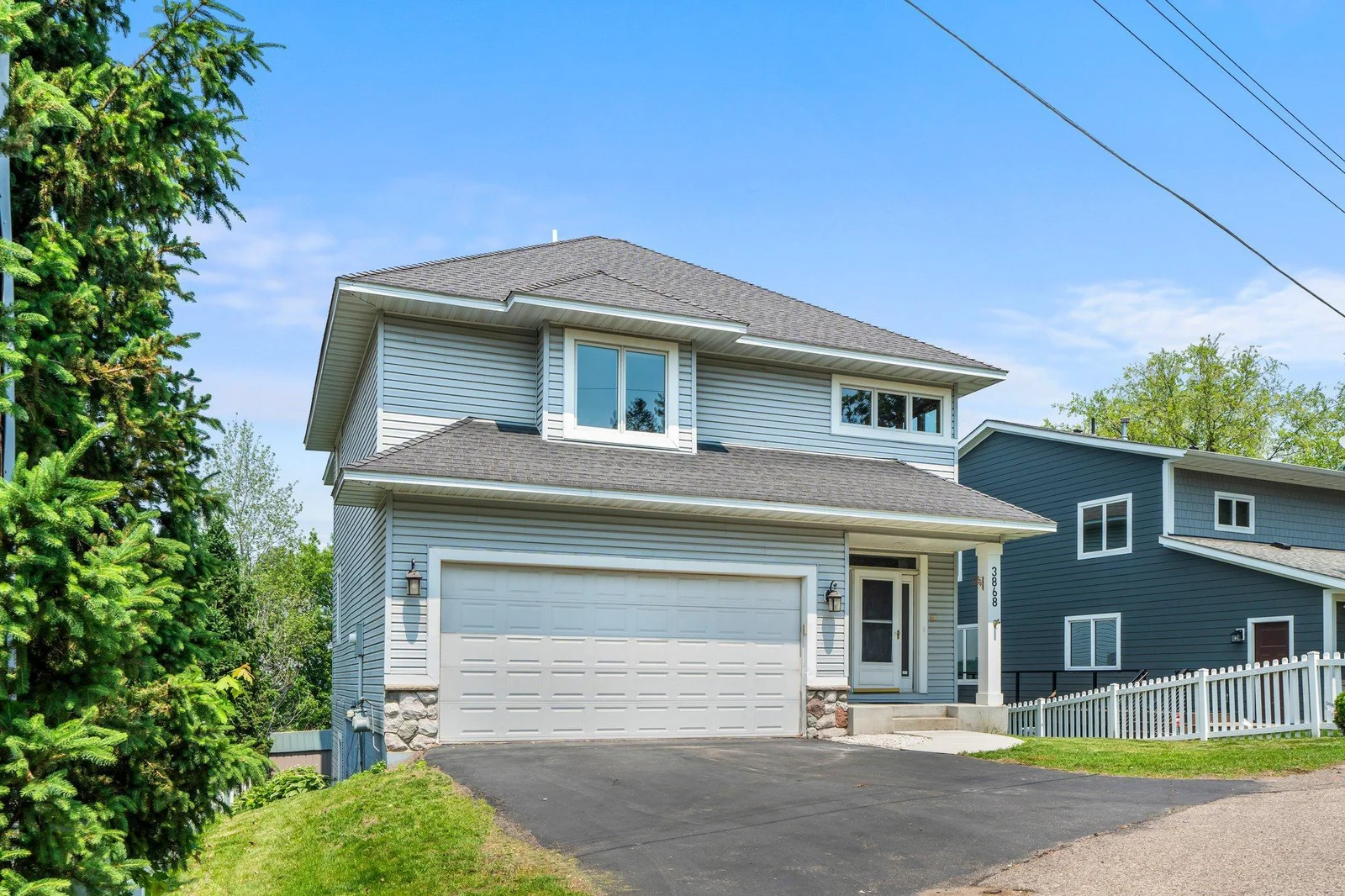 Front of home offers a 2-car garage