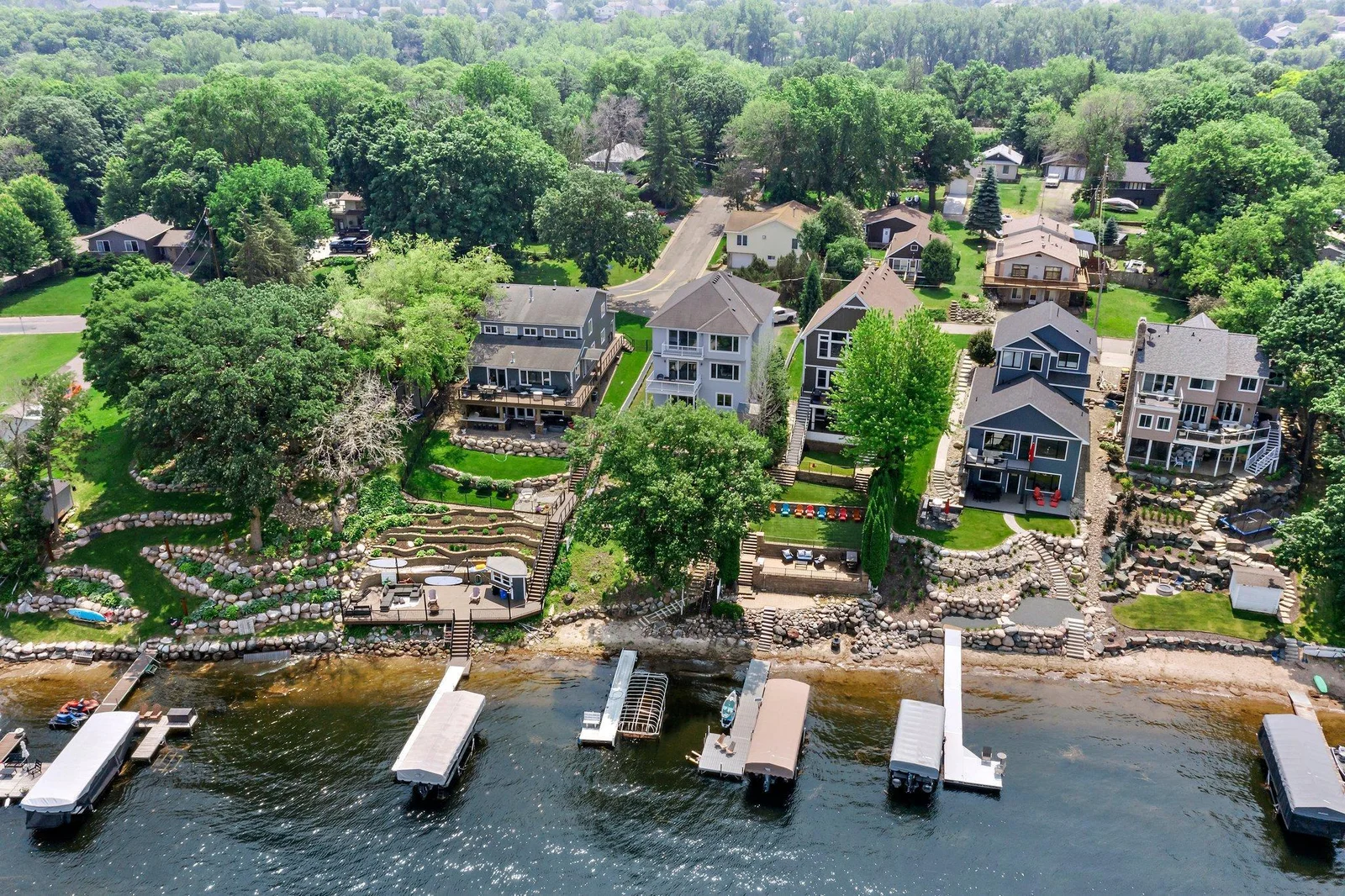 Stairs lead down to a sandy beach & dock on Prior Lake!