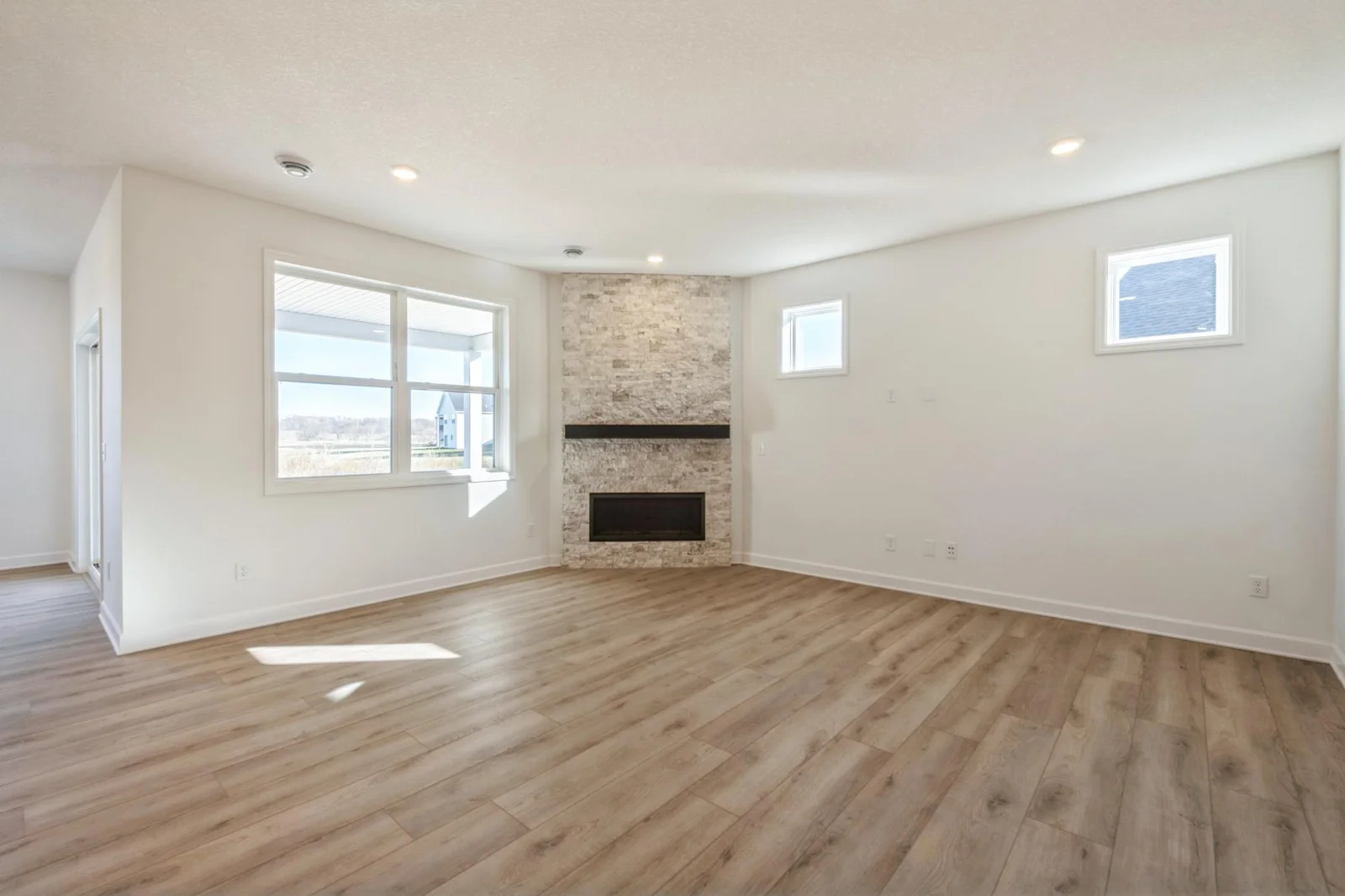Photo is of the actual home. The Great Room features a full height fireplace! A perfect place to relax and create memories.