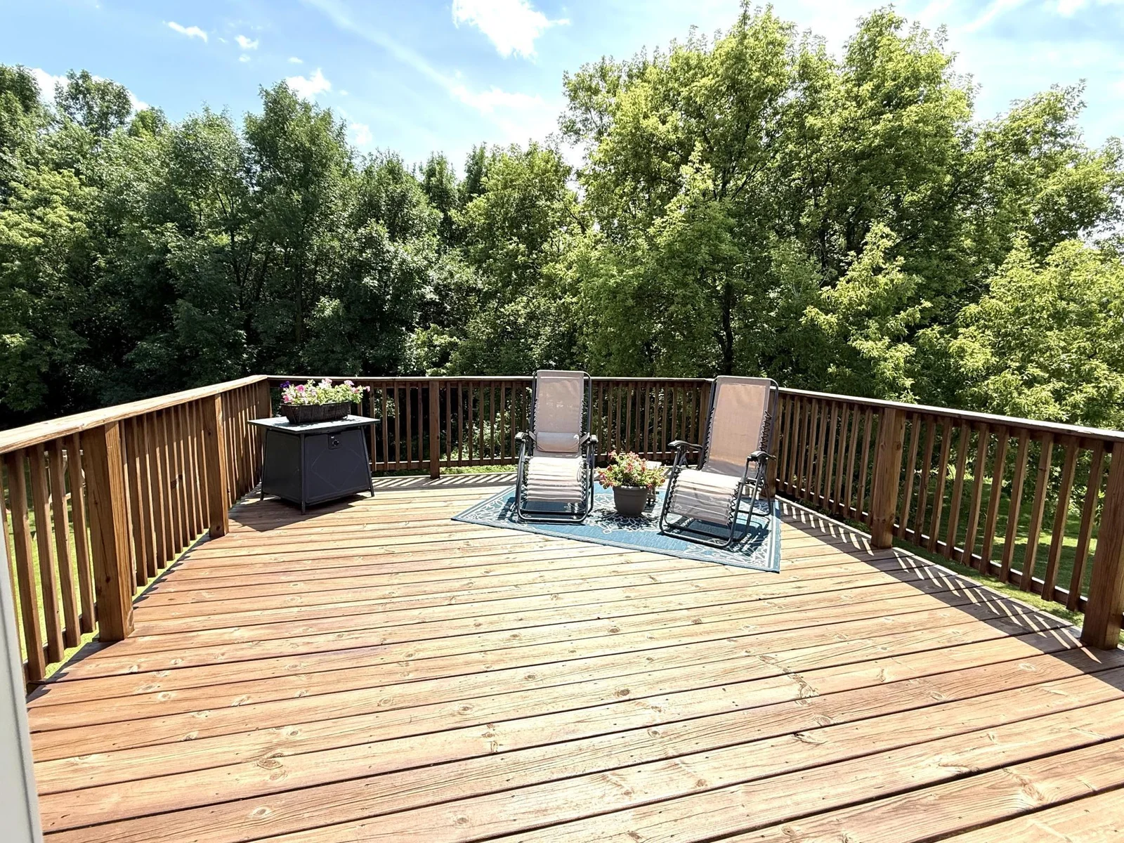 Sit and Enjoy the views from the deck! Overlooks deep backyard and woods area.