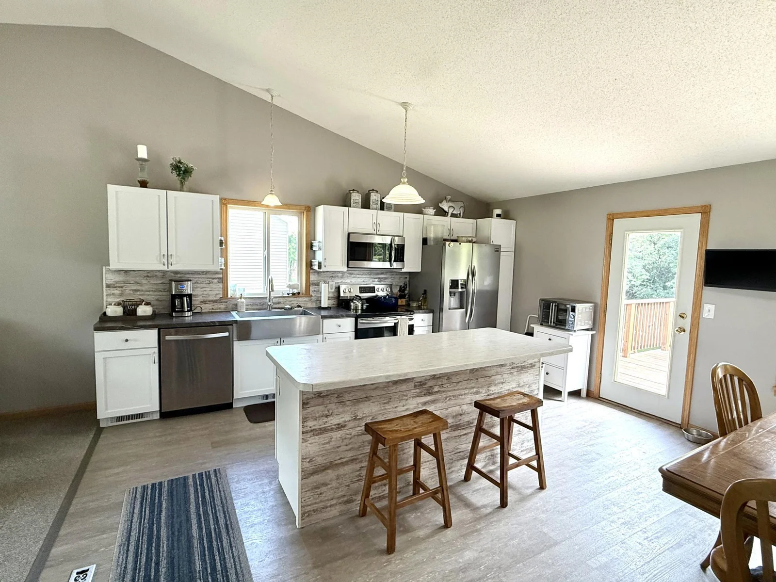 Beautiful Open Kitchen Area! All appliances Included! Walkout to deck overlooking backyard area with woods!