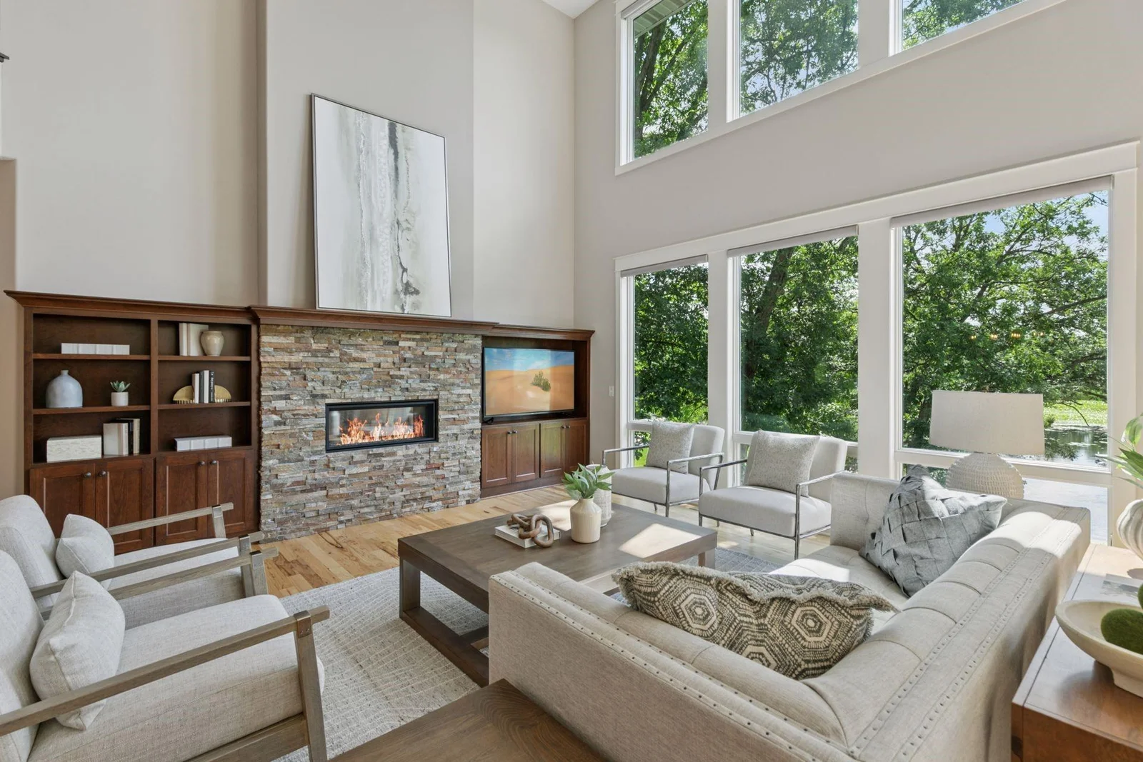 Stacked stone surround gas fireplaced flanked with custom built-ins