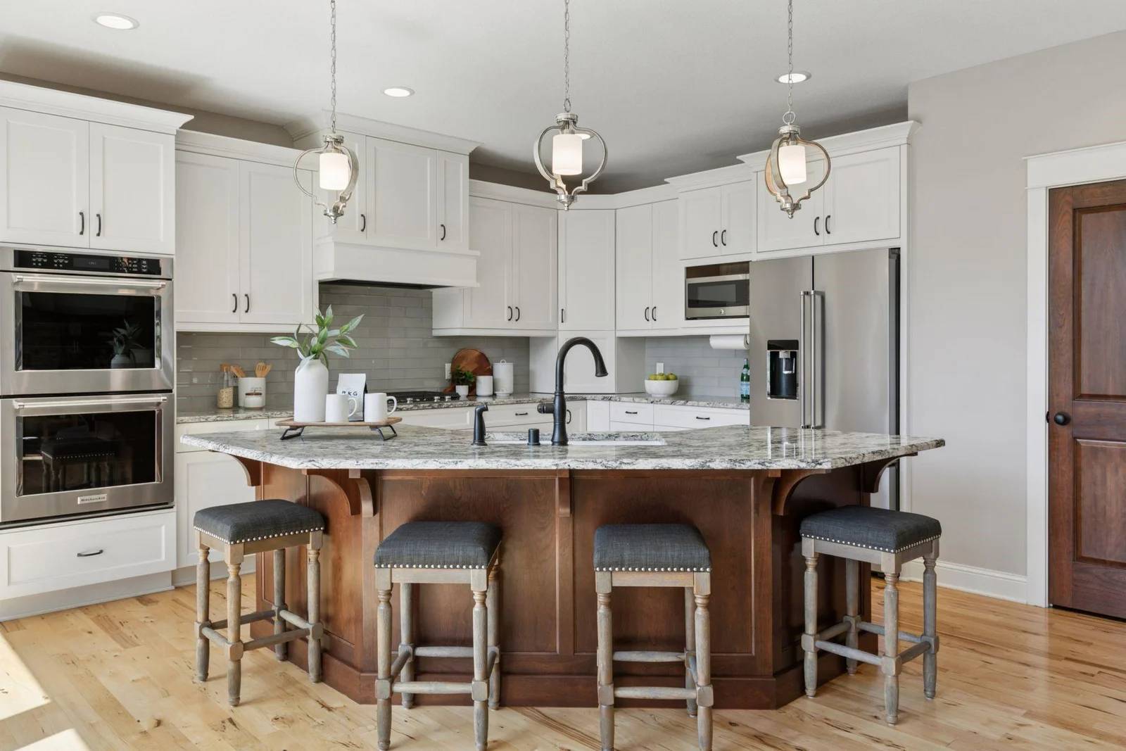 Custom Kitchen with stainless appliances, generous island, custom cabinetry, gorgeous countertops, stylish lighting, ample storage.